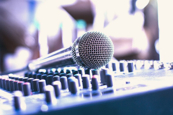 Analog microphone with recording equipment in the control room.